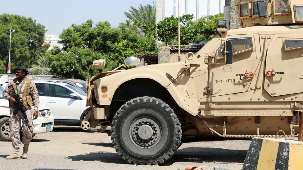 A Saudi soldier walks past an armoured vehicle in Aden, Yemen (6 November 2019)