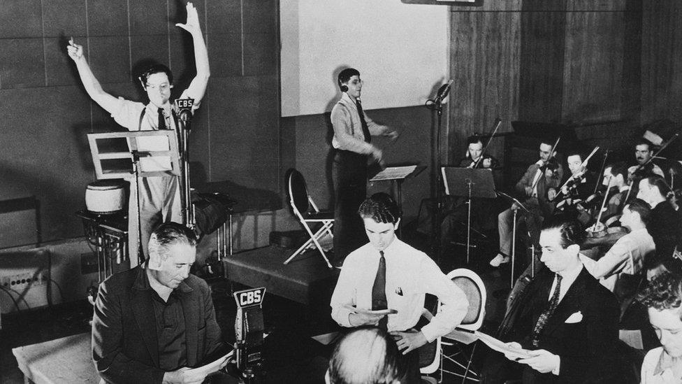 Orson WELLES (with the microphone) rehearsing one of his radio programs on CBS.