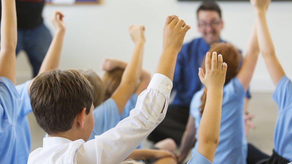 Stock photo of children in a classroom.