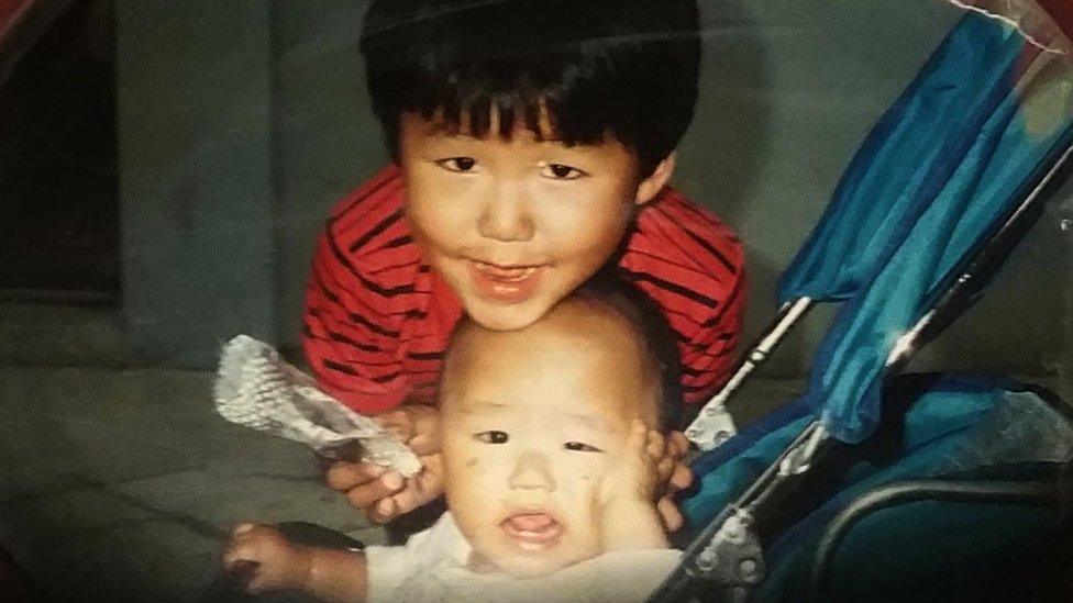 A family photo of Jang and his brother Jun-an as children