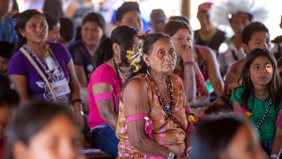 A Cinta Larga woman stares ahead during a meeting