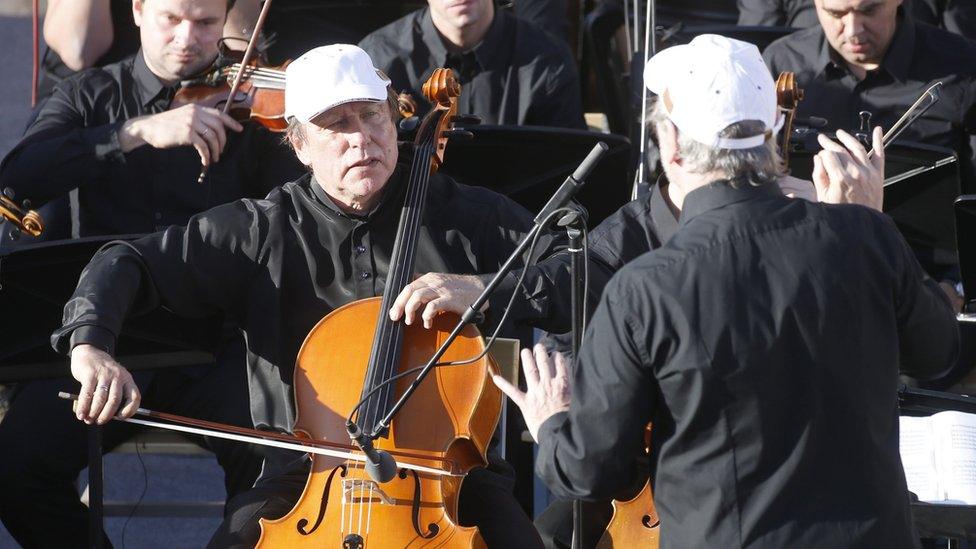 Russian cellist and friend of Vladimir Putin Sergei Roldugin (2-L) performs during a concert by the Mariinsky Theater Orchestra in Palmyra amphitheatre in Tadmur District, Homs Governorate, Syria, 05 May 2016.