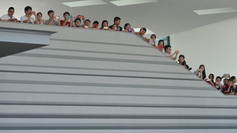 Students wait for Chinese President Xi Jinping (not pictured) to leave the 36th Singapore Lecture at National University of Singapore on November 7, 2015.