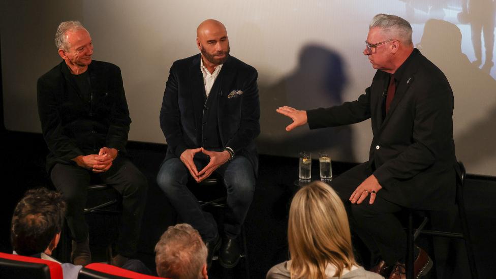 Iain Softley, John Travolta and Mark Kermode attend a screening of Disney + Original Short Film "The Shepherd" at W London on November 23, 2023 in London, England