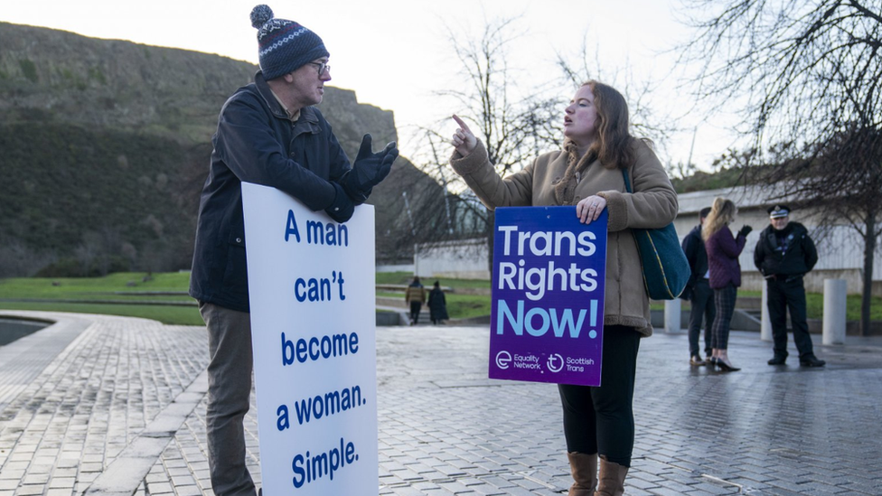 A member of the Scottish Family Party speaks with a Gender Recognition Reform Bill supporter outside the Scottish Parliament, Edinburgh