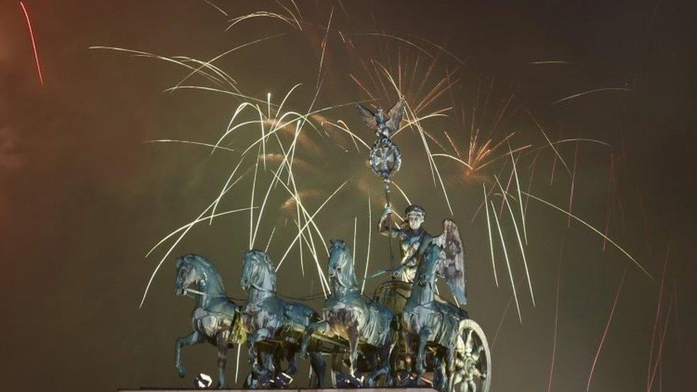 Fireworks explode next to the Quadriga sculpture atop the Brandenburg gate during New Year celebrations in Berlin (01 January 2016)