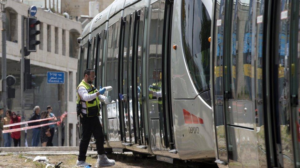 Israeli medical personnel inspect the scene of the attack