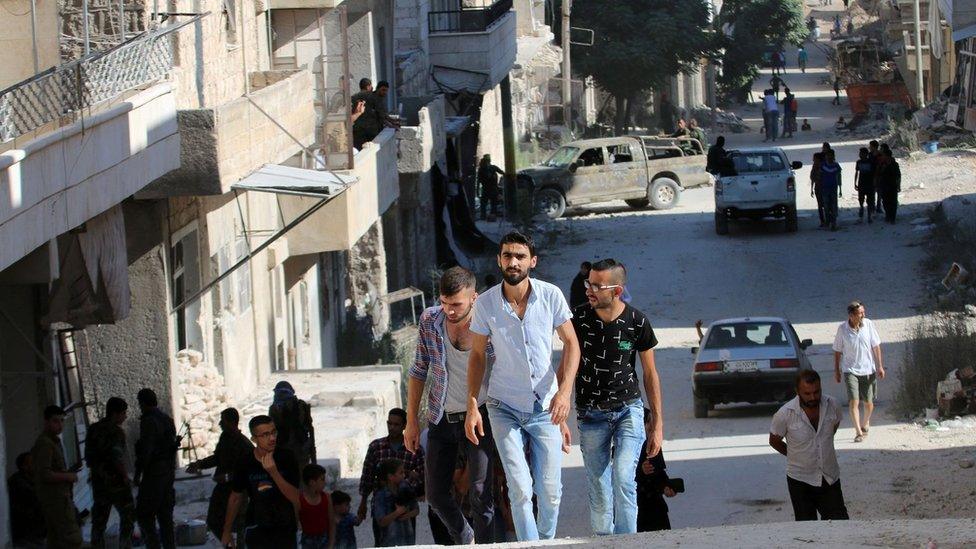 People come back to Bani Zeid on July 29 2016, after Syrian government forces retook control of it.