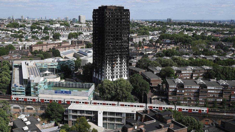 Grenfell Tower with a Tube train passing nearby