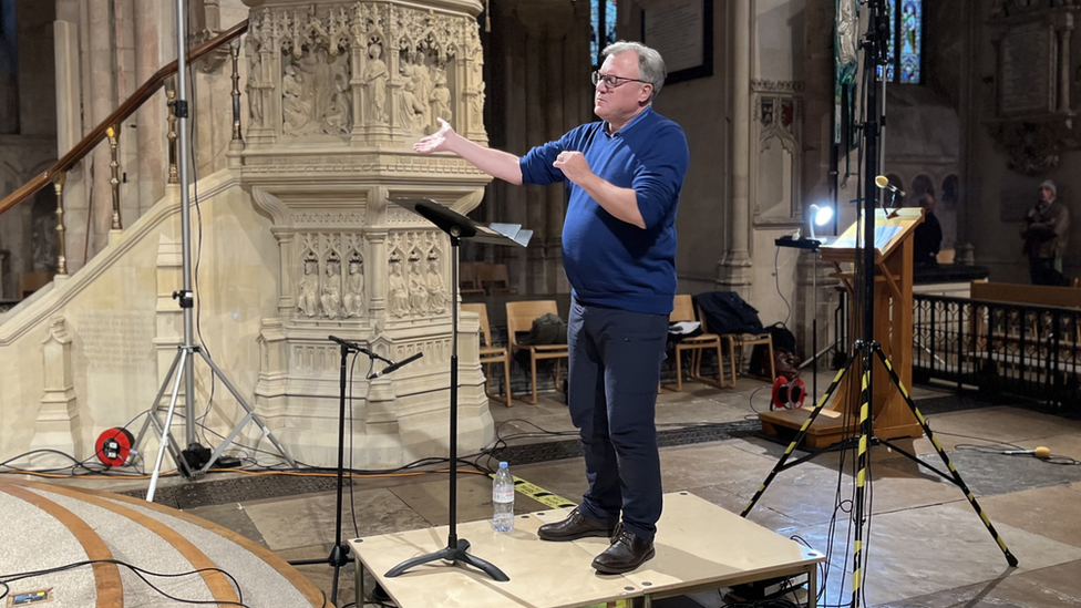 Former MP conducting in rehearsals in Norwich Cathedral