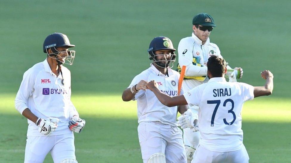 Rishabh Pant (C) of India celebrates with team mates Navdeep Saini (L) and Mohammed Siraj (R) after winning on day five of the fourth Test Match between Australia and India at the Gabba in Brisbane, Australia, 19 January 2021.