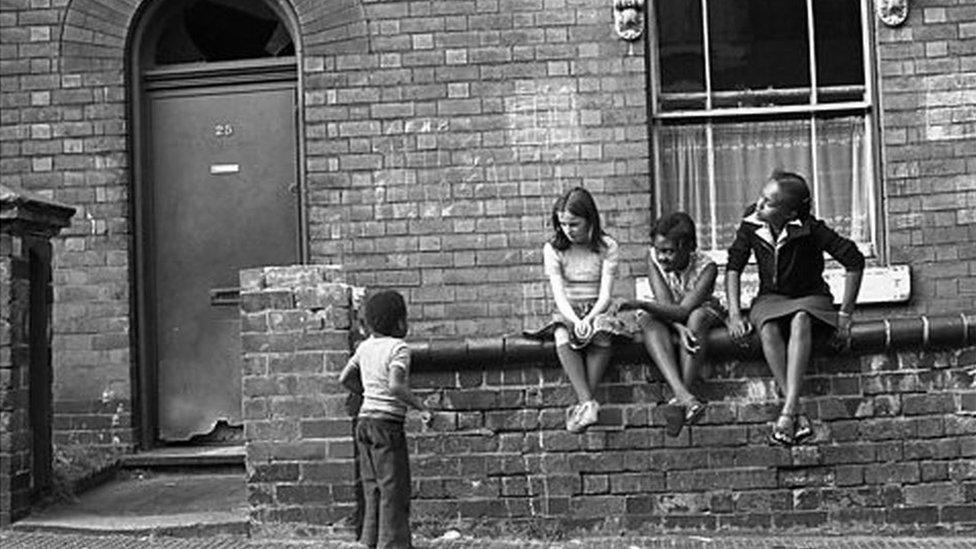 Children sitting on wall in 1991