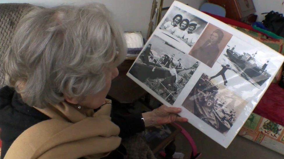 Mollie looking at some photographs of her wartime service