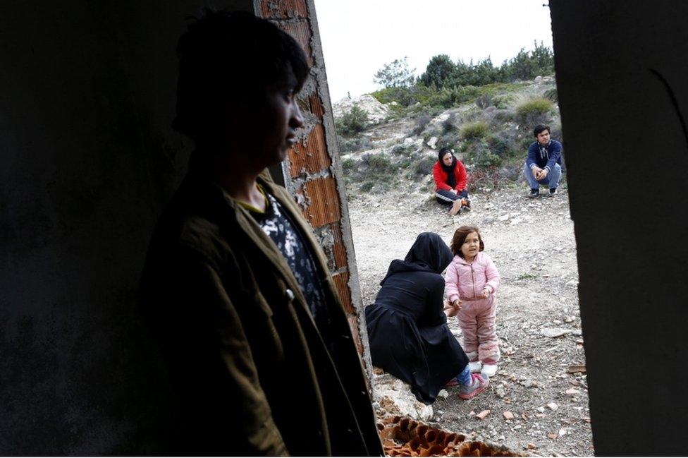 Afghan refugees wait before travelling to the Greek island of Chios, in Cesme district, Izmir, Turkey, 6 March 2016.