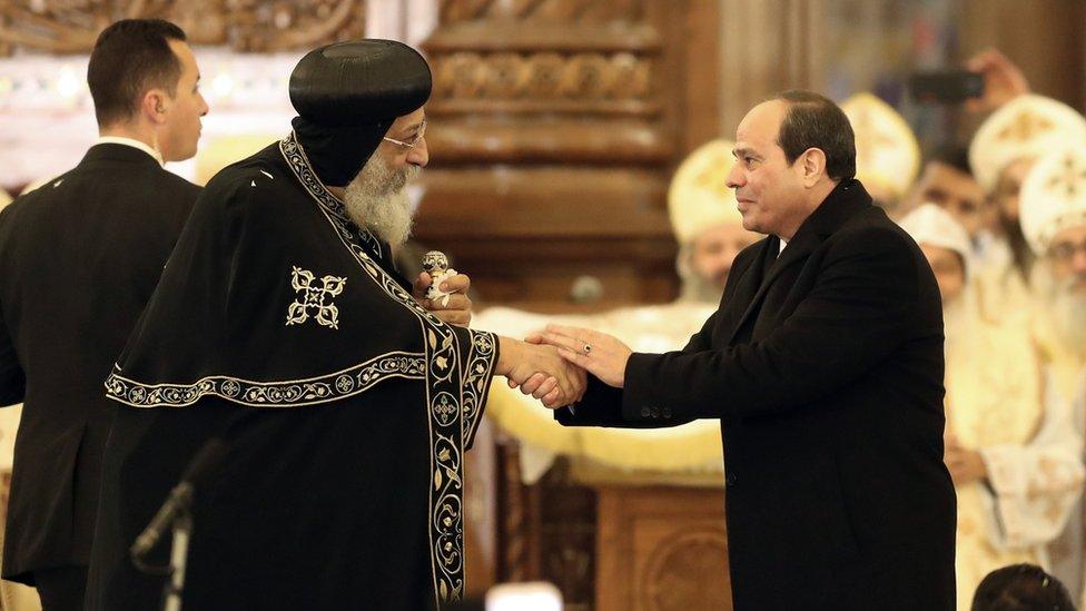 Pope Tawadros II of Alexandria (L) listens as Egyptian President Abdel Fattah al-Sisi (R) speaks before mass at the newly inaugurated Cathedral of Nativity in the New Administrative Capital, Egypt