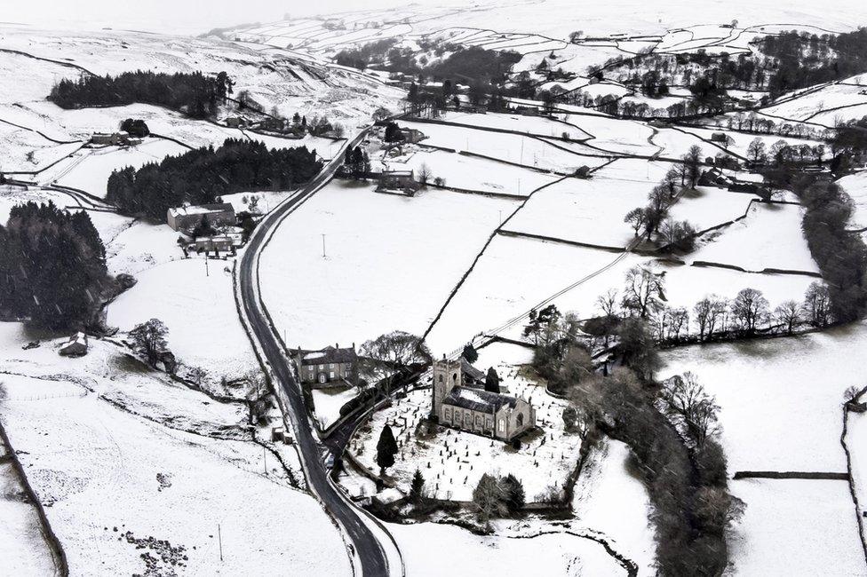 Snow covered fields and hills surround St Mary The Virgin Church in the Arkengarthdale, North Yorkshire, amid freezing conditions in the aftermath of Storm Arwen