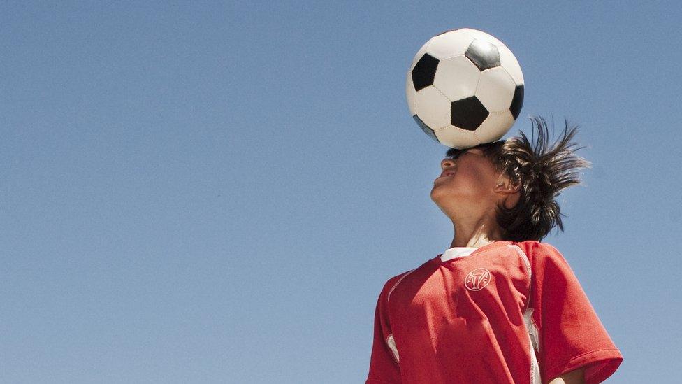 Boy heading a football