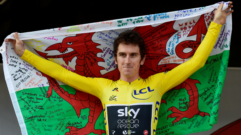 Geraint Thomas holding a Wales flag