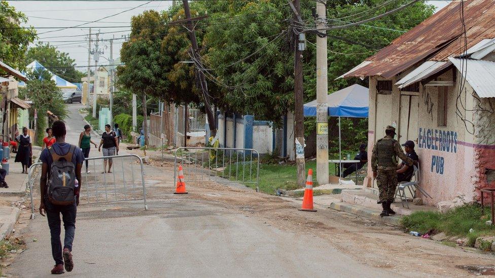 Police and soldiers man a checkpoint in Denham Town