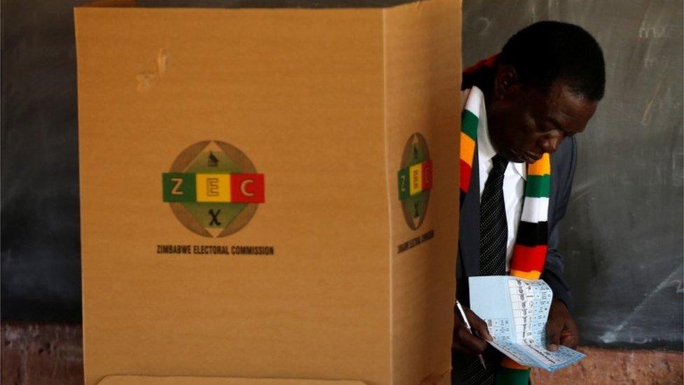 President Emmerson Mnangagwa checks his papers as he casts his ballot to vote in the country's general election, at Sherwood Park Primary School in Kwekwe, Zimbabwe July 30, 2018.