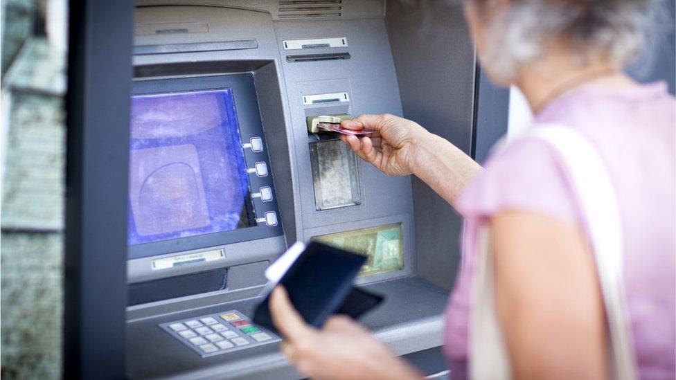 Woman at cash machine