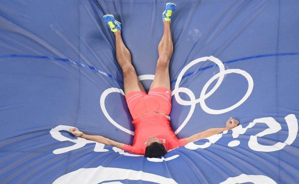 Mr Ogita lying on the crash mat after a jump