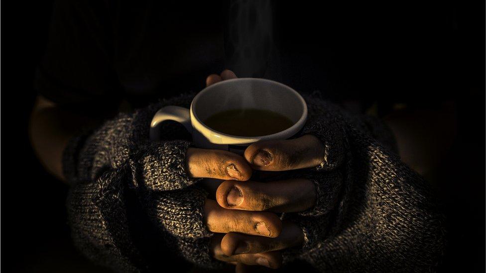 Homeless man with cup of tea