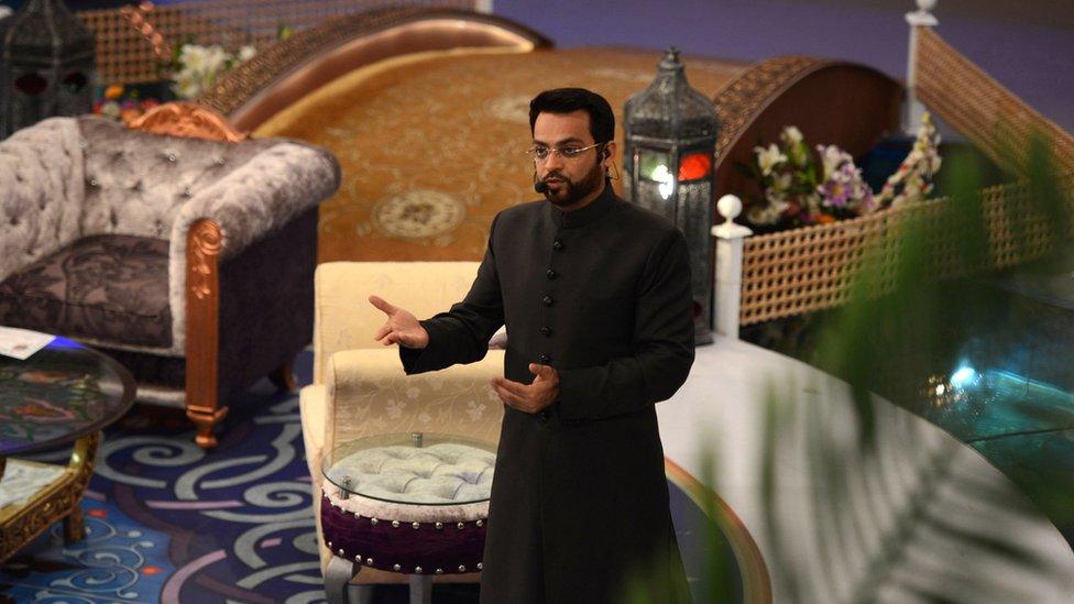 In this photograph taken on 31 July 2013, Pakistani television show host Aamir Liaqat Hussain presents an Islamic quiz show Aman Ramadan in Karachi.