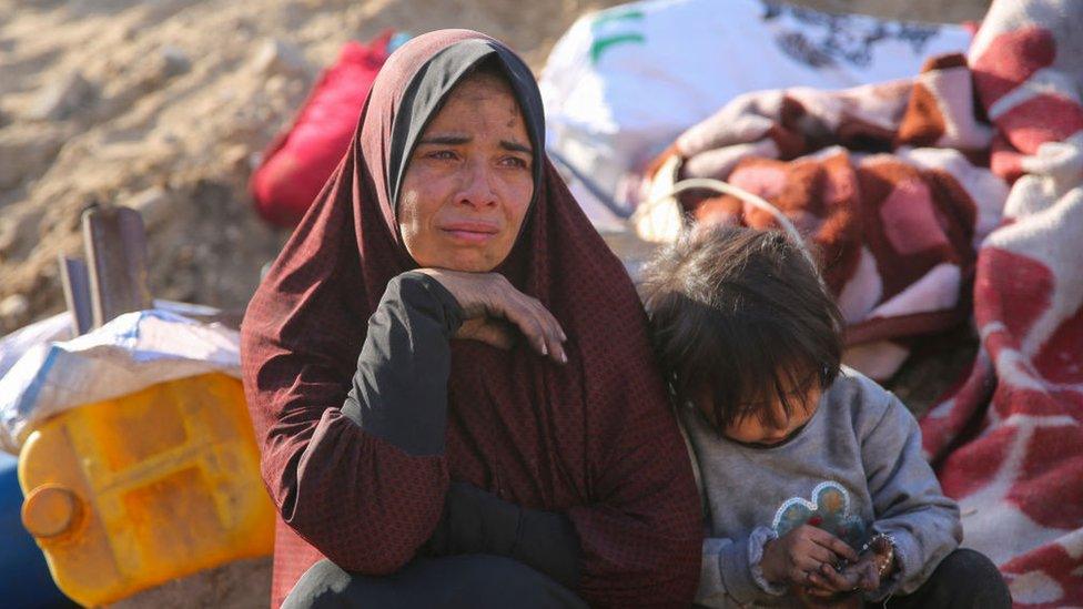 A Palestinian woman weeps as she sits amidst the rubble of Gaza's Al-Shifa hospital on 1 April