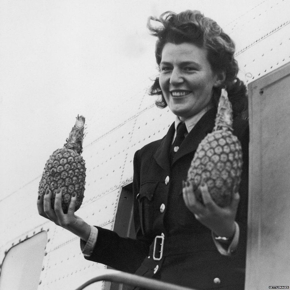 British South American Airways hostess Mary Guthrie with a pair of pineapples, 15 January 1946