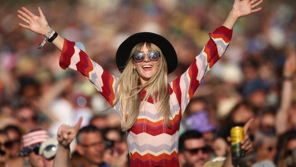 Woman in crowd at Glastonbury 2023