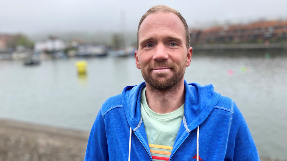 John Palmer standing in front of Bristol Harbour