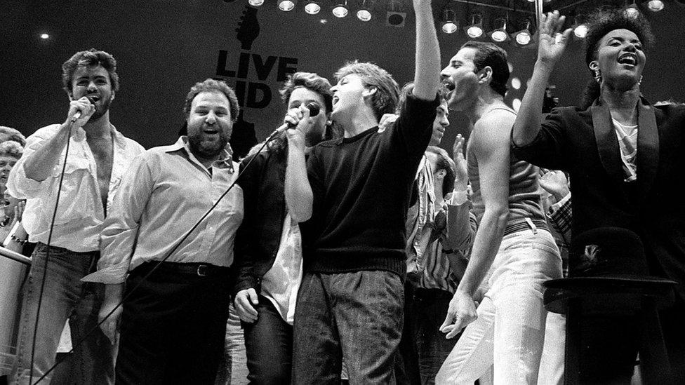 George Michael (far left) with Bono, Paul McCartney and Freddie Mercury during the finale of Live Aid in 1985