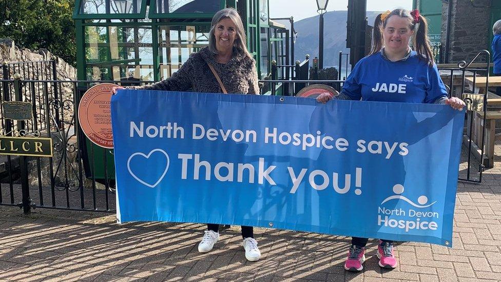 mum and jade holding sign