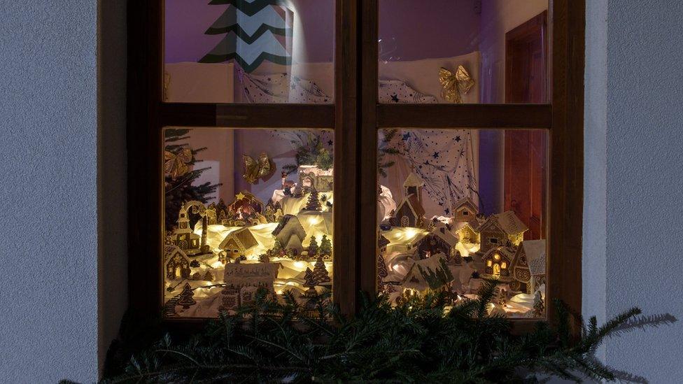 Gingerbread village seen through a window.