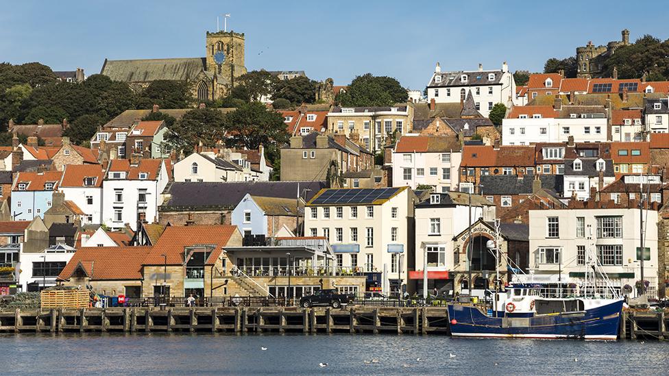 Colourful waterfront houses and a boat pictured in Scarborough in 2016