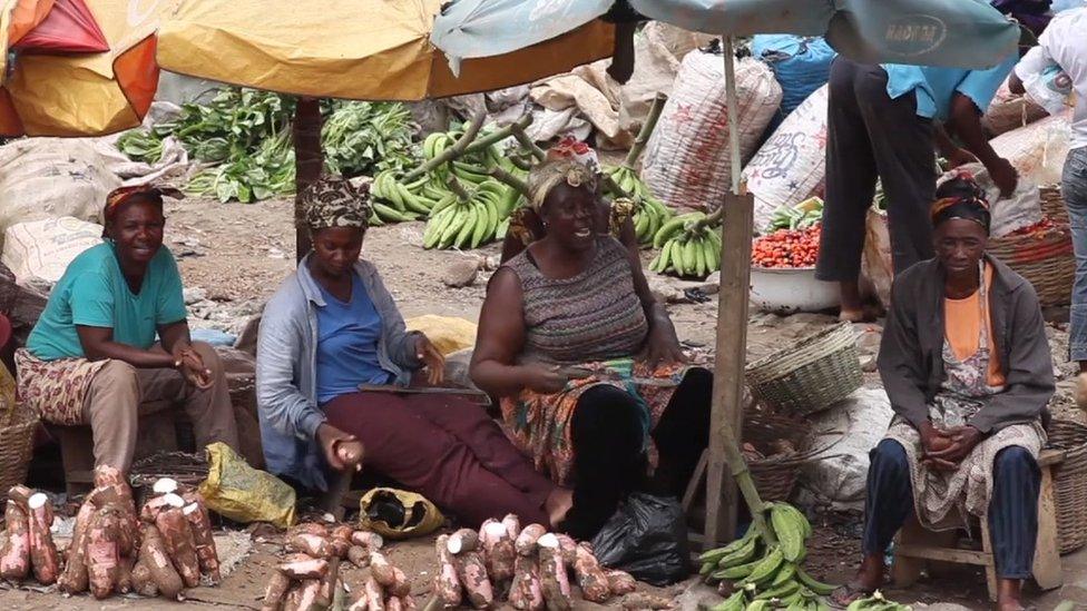 Women preparing vegetables at a market