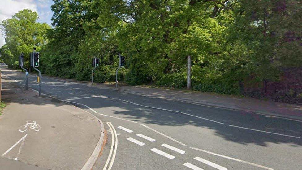 A junction on Hill Lane, Southampton, with no traffic and traffic lights at green