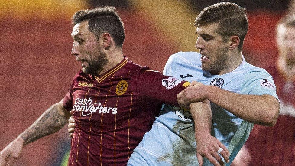 Motherwell's Scott McDonald holds off Partick Thistle's Frederic Frans