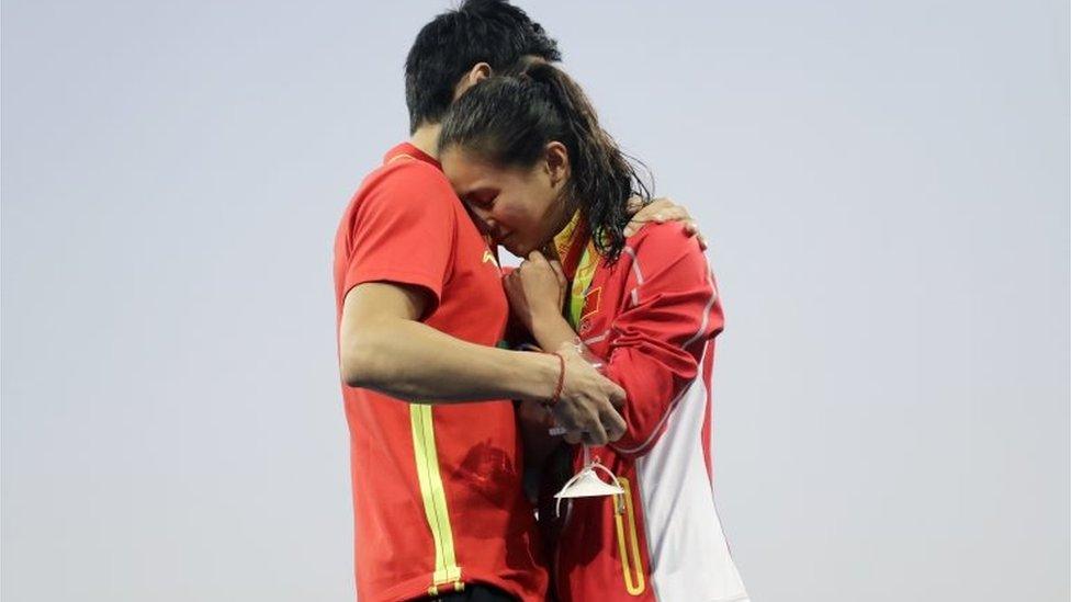 China"s diver Qin Kai, left, proposes to silver medalist He Zhi of the women"s 3-meter springboard diving finals in the Maria Lenk Aquatic Center at the 2016 Summer Olympics in Rio de Janeiro, Brazil, Sunday, Aug. 14, 2016.