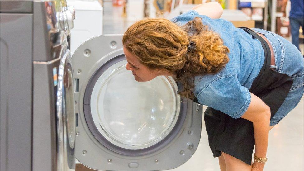 woman buying washing machine