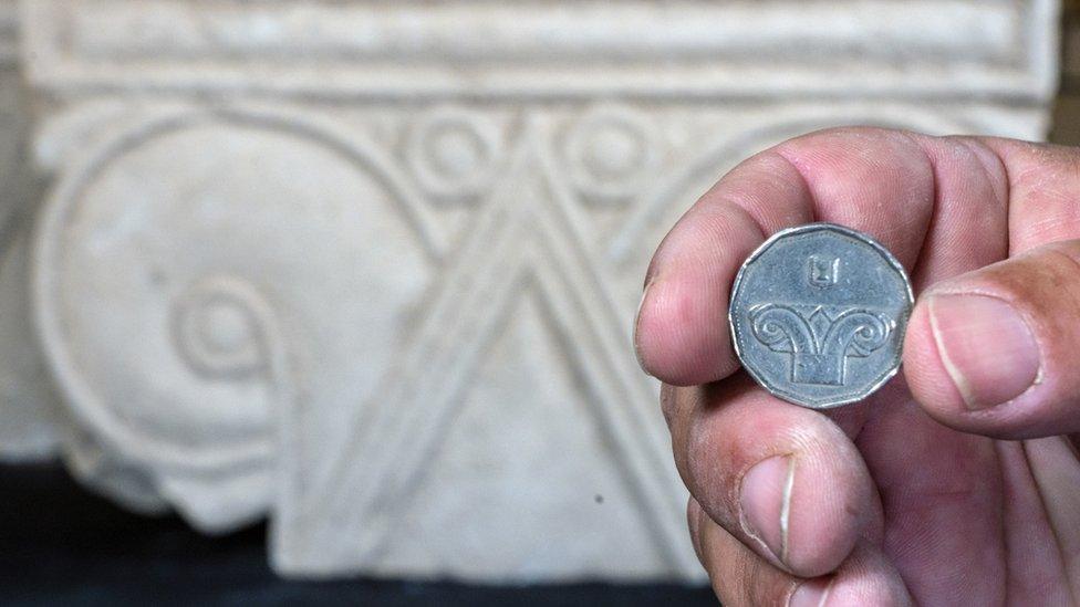 Five shekel coin against the background of the capital discovered