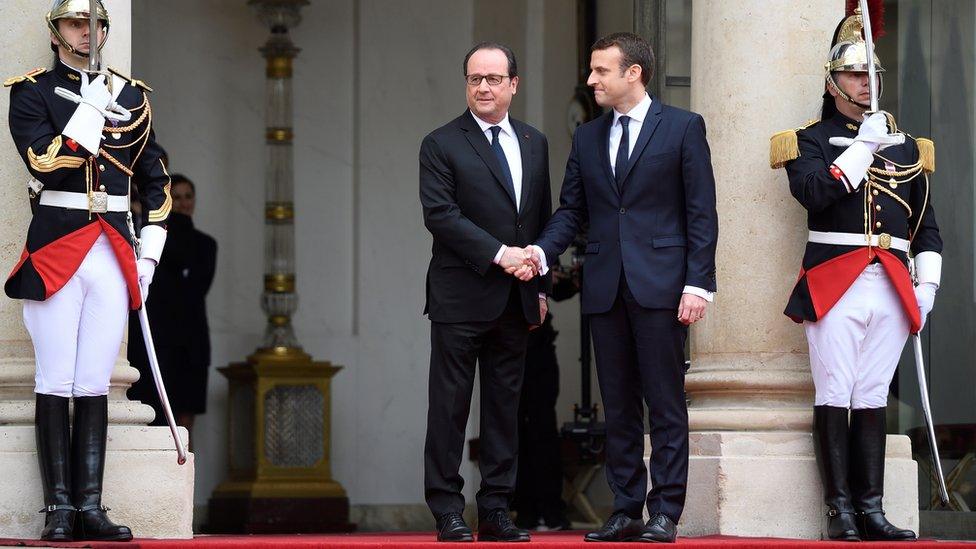 Emmanuel Macron is welcomed by his predecessor Francois Hollande at the Elysee Palace for inauguration ceremonies on May 14, 2017