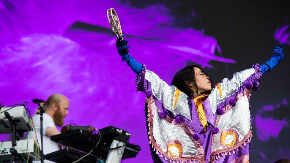 Yukimi Nagano, lead singer of Little Dragon, playing a tambourine