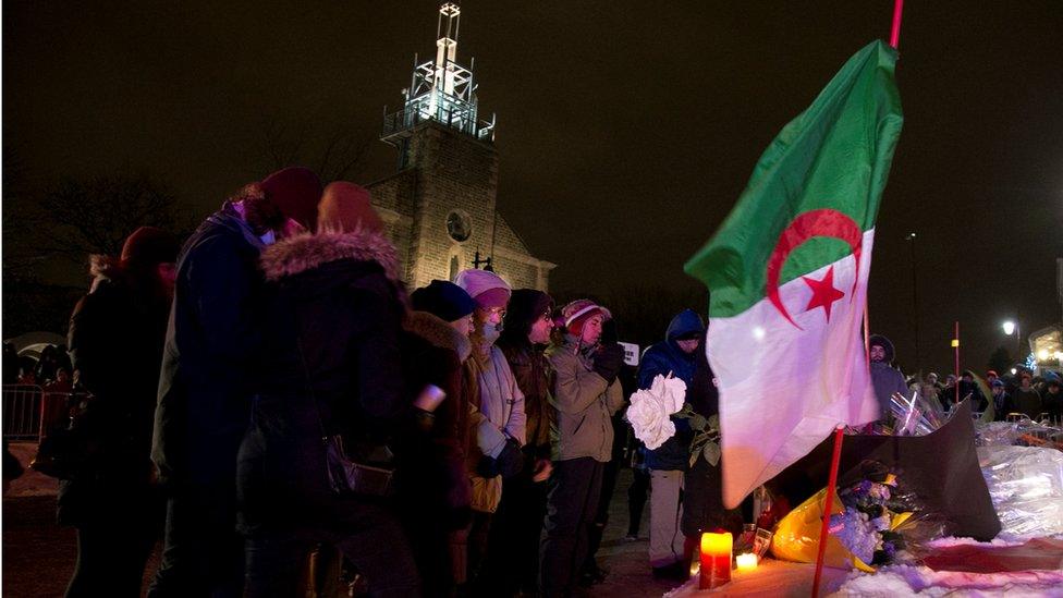 people pay respects at a make-shift memorial following a vigil held in honour of the victims of a shooting in a Quebec mosque in Quebec City, Quebec January 30, 2017.