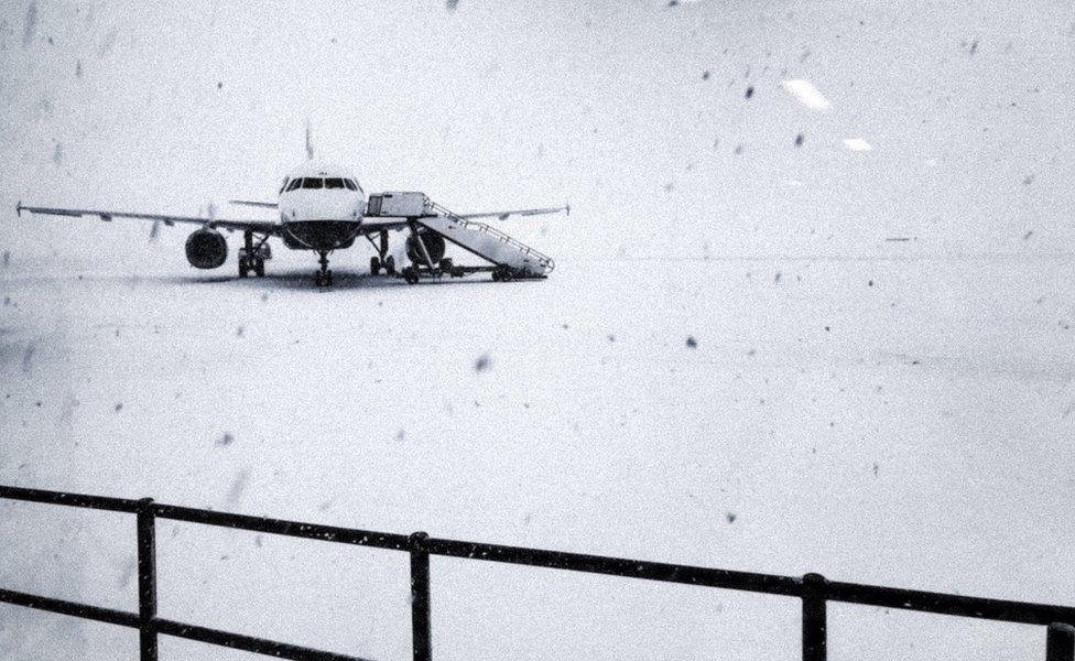 Heavy snow falls on the tarmac of the Glasgow Airport in Glasgow