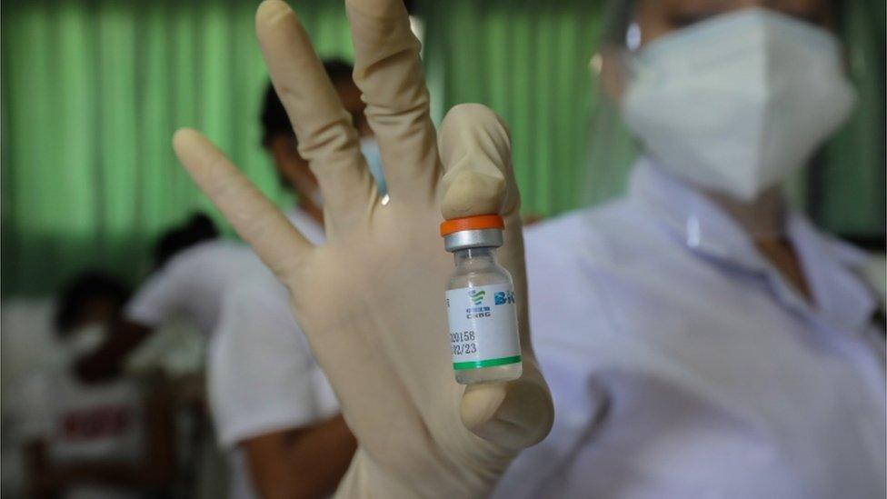 A health worker prepares to administer the first shot of China"s Sinopharm COVID-19 vaccine in Colombo