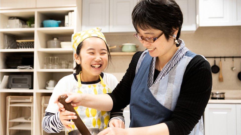 child cooking with parent