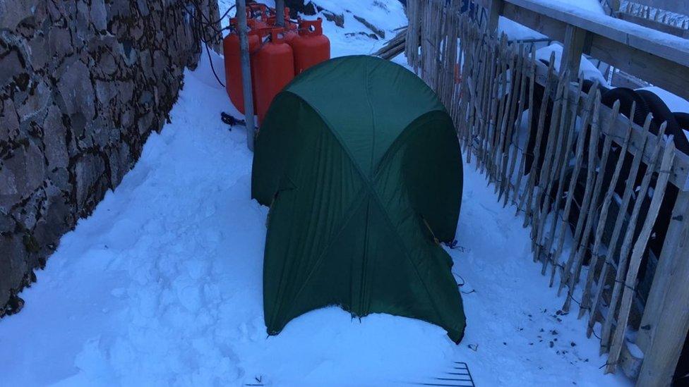 Couple's green tent behind the Charles Inglis Clark (CIC) memorial hut on the north side of the mountain