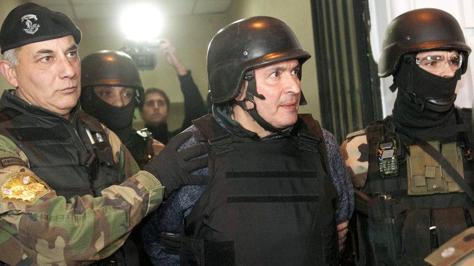 Former Public Works Secretary Jose Lopez (C) is escorted by members of the special police group in Buenos Aires, Argentina, 14 June 2016